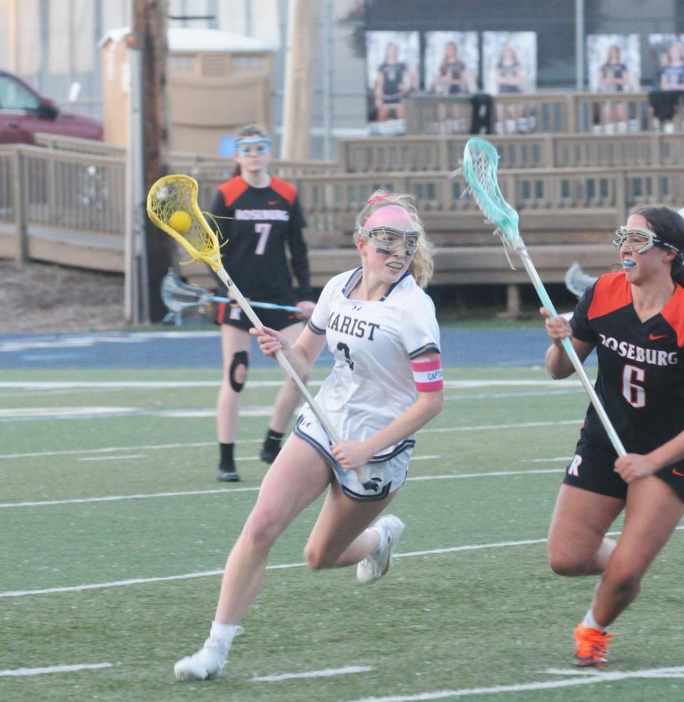 Marist's McKenna De Lee (3) controls the ball during a lacrosse game versus Roseburg at Marist Catholic High School, Tuesday, May 7, 2024.