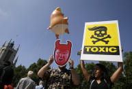 <p>Protestors hold up banners as a six-meter high cartoon baby blimp of U.S. President Donald Trump, as it is flown as a protest against his visit, in Parliament Square in London, England, Friday, July 13, 2018. (Photo: Tim Ireland/AP) </p>