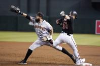 San Francisco Giants first baseman Brandon Belt, left, makes the catch at first base for the out on Arizona Diamondbacks' Christian Walker during the second inning of a baseball game Wednesday, July 6, 2022, in Phoenix. (AP Photo/Ross D. Franklin)