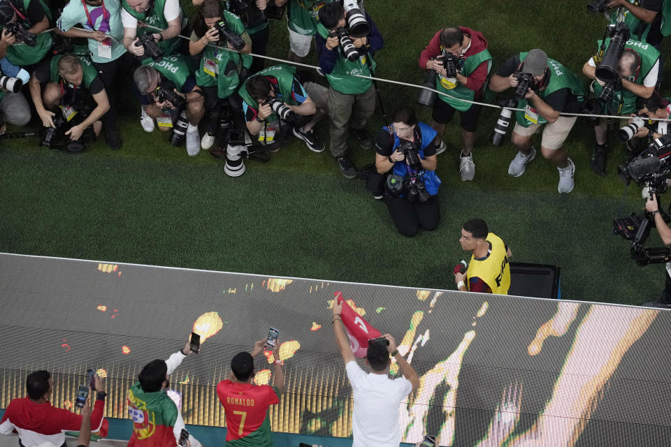 Portugal's Cristiano Ronaldo, center, walks to his team bench at the beginning of the World Cup round of 16 soccer match between Portugal and Switzerland, at the Lusail Stadium in Lusail, Qatar, Tuesday, Dec. 6, 2022. (AP Photo/Thanassis Stavrakis)