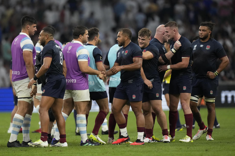 England players shake hands with the Argentine players after the end of the during the Rugby World Cup Pool D match between England and Argentina in the Stade de Marseille, Marseille, France Saturday, Sept. 9, 2023. (England won the game 27-10. AP Photo/Pavel Golovkin)