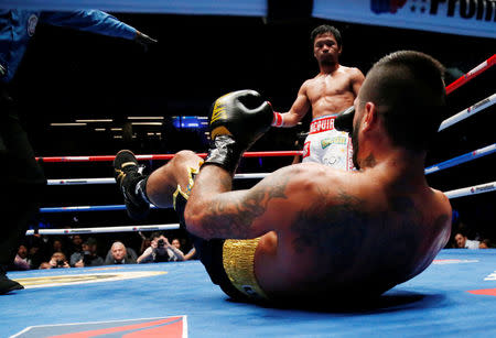 Boxing - WBA Welterweight Title Fight - Manny Pacquiao v Lucas Matthysse - Axiata Arena, Kuala Lumpur, Malaysia - July 15, 2018 Manny Pacquiao in action against Lucas Matthysse REUTERS/Lai Seng Sin