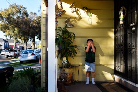 Alexander Avila, 3, who suffers the symptoms of lead poisoning contracted from lead-based paint stands outside his home in Oakland