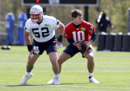 New England Patriots first round quarterback draft pick Drake Maye (10) takes a snap from Joey Ramos (52) during the NFL football team's rookie minicamp Saturday, May 11, 2024, in Foxborough, Mass. (AP Photo/Mark Stockwell)