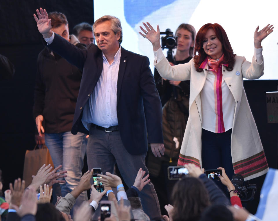 Presidential candidate Alberto Fernandez, left, and his running-mate, former President Cristina Fernandez, no relation, greet supporters during their kick-off campaign rally in Buenos Aires, Argentina, Saturday, May 25, 2019. Argentina will hold general presidential elections on Oct 27. (AP Photo/Gustavo Garello)