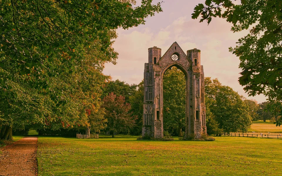Walsingham Abbey's fourteenth century window arch, part of the remains of the priory church and original site of a pilgrimage shrine until destroyed in the sixteenth century by order of Henry VIII - Getty