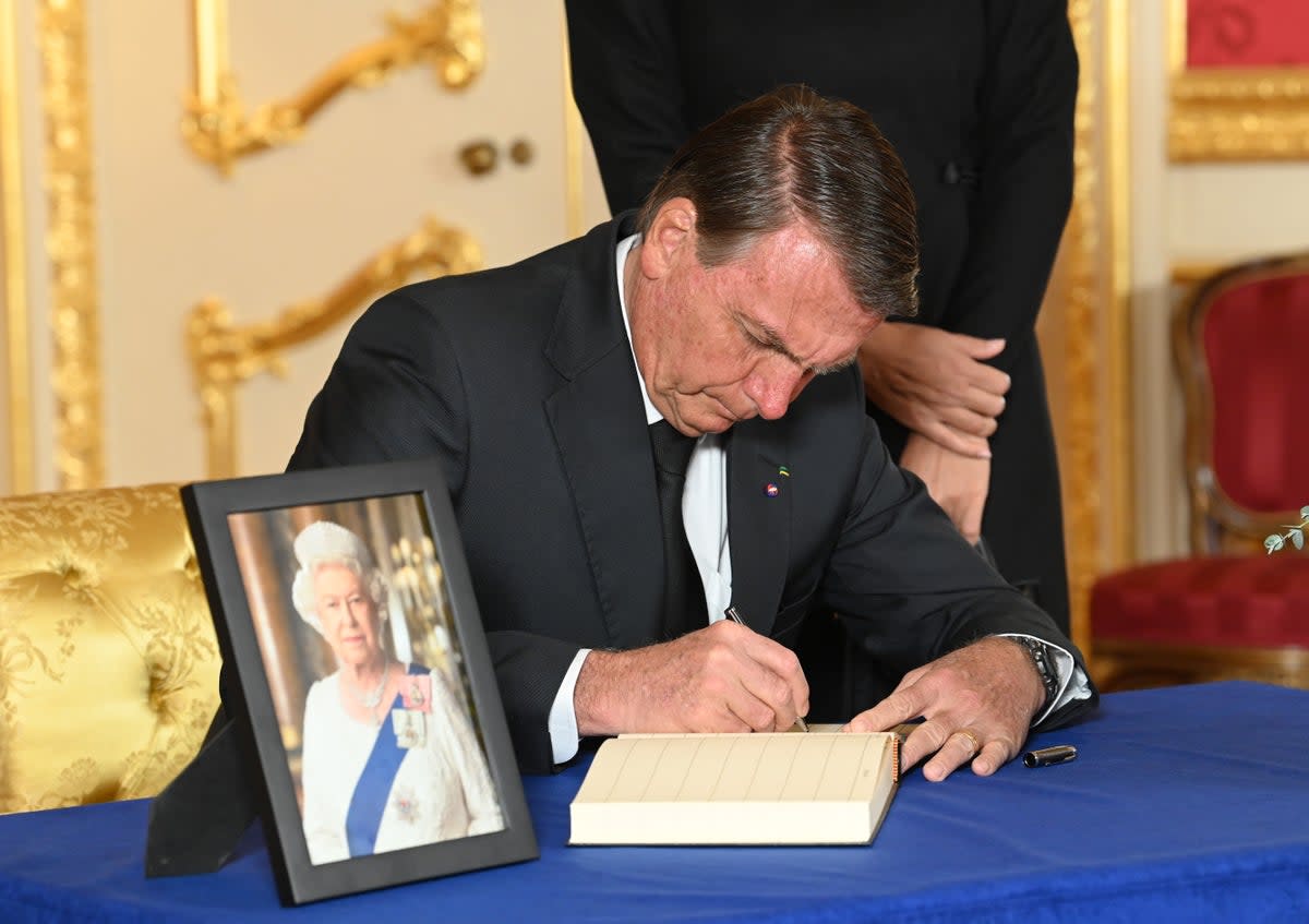 Brazilian President Jair Bolsonaro signs a book of condolence at Lancaster House on September 18, 2022 in London (Getty Images)