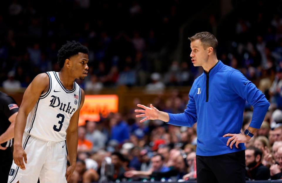 Duke head coach Jon Scheyer speaks with Jeremy Roach during the second half of a men’s basketball game at Cameron Indoor Stadium on Saturday, Jan. 21, 2023, in Durham, N.C.