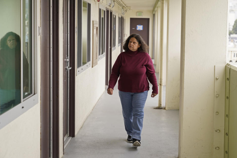 Former census taker Linda Rothfield walks past a number of apartments in a building where she currently works in San Francisco, on Wednesday, June 30, 2021. Some census takers worry that renters in apartment buildings were not tallied fully during the nation's head count last year. Census takers say they had difficulty entering apartment buildings due to COVID restrictions, and they weren't able to get in touch with landlords for help. (AP Photo/Eric Risberg)