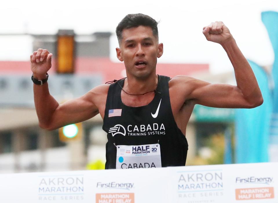 Fernando Cabada heads to the finish line for a first-place finish in the men's half-marathon Saturday in Akron.