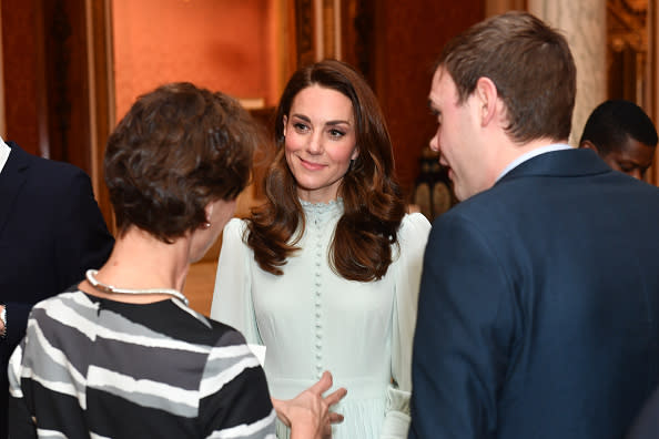 Catherine, Duchess of Cambridge speaks to guests as she attends a reception to mark the fiftieth anniversary of the investiture of the Prince of Wales at Buckingham Palace in London on March 5, 2019.