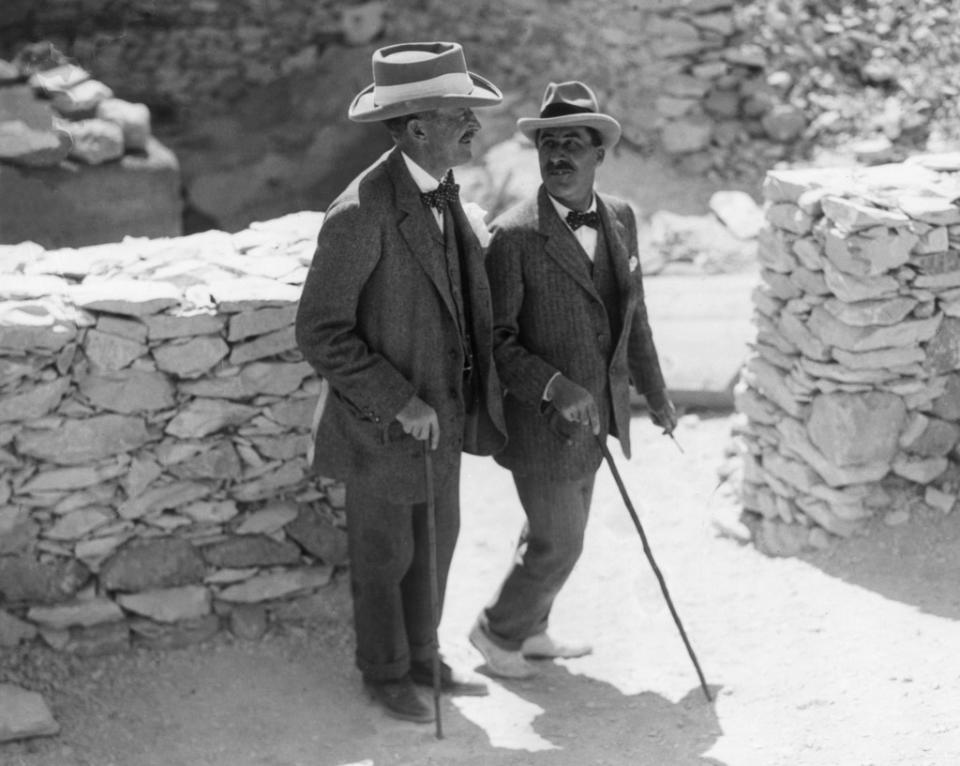 Egyptologist Howard Carter (R) walks with archaeologist Lord Carnarvon, the patron of his research, outside the tomb of King Tutankhamun in 1922. Getty Images