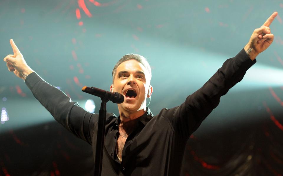 Robbie Williams performs on stage at Key 103 Christmas Live at Manchester Arena - Shirlaine Forrest/Getty Images