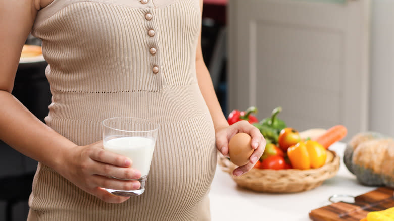 Pregnant woman holding an egg