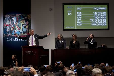 Auctioneer Jussi Pylkkanen calls for final bids before dropping the gavel as he sells Pablo Picasso's "Les femmes d'Alger (Version 'O')" (Women of Algiers) at Christie's Auction House in the Manhattan borough of New York May 11, 2015. REUTERS/Carlo Allegri