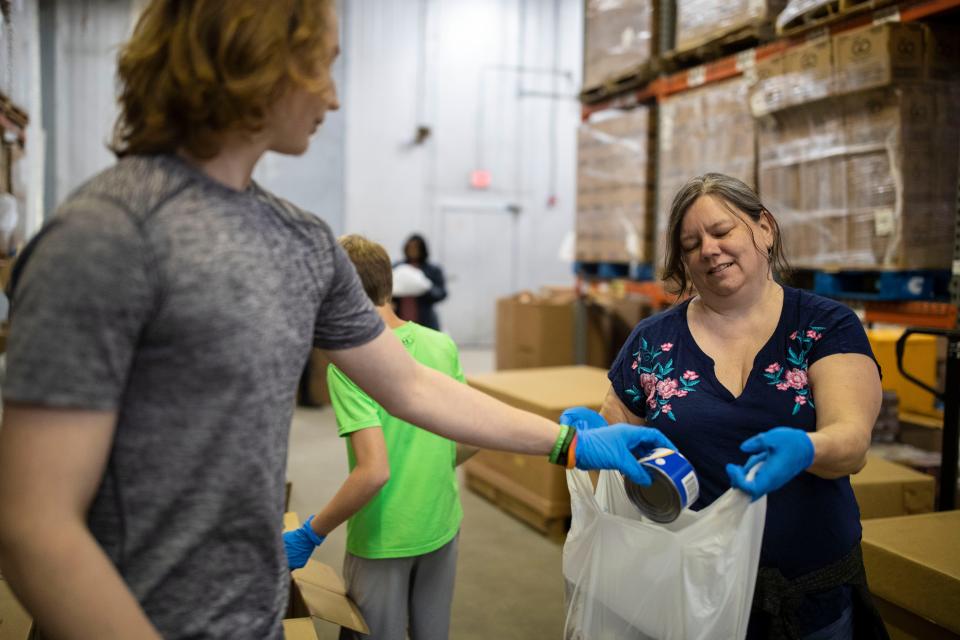 Volunteers bag food at Second Harvest Food Bank, which will be given out to students in the Big Bend, Tuesday, March 17, 2020. 