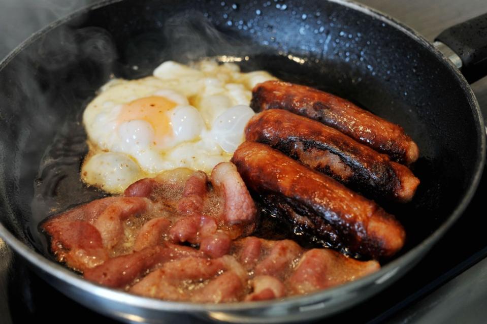 Egg, sausages and bacon being fried in a frying pan (Nick Ansell/PA) (PA Archive)