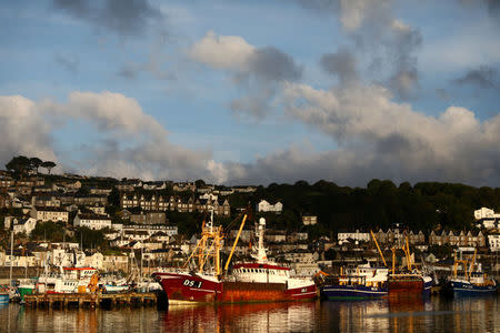 FILE PHOTO: The sun rises at a port in Newlyn, Britain August 10, 2017. REUTERS/Neil Hall/File Photo