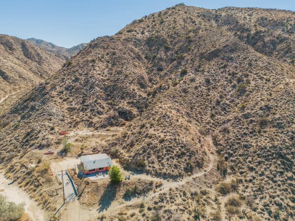 Surrounded by pristine desert, the darling pink home presents a serene urban escape all while offering convenient access to the popular hotspots of Palm Springs and Joshua Tree.