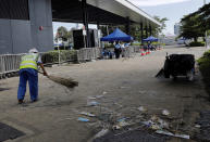 A worker cleans up in the aftermath of Wednesday's violent protest against the proposed amendments to extradition law near the Legislative Council in Hong Kong on Friday, June 14, 2019. Calm appeared to have returned to Hong Kong after days of protests by students and human rights activists opposed to a bill that would allow suspects to be tried in mainland Chinese courts. (AP Photo/Vincent Yu)