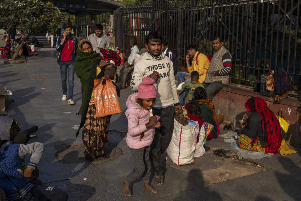 Five years-old Srishtri Kumari walks with her father as her mother Savita Devi, follows them outside the All India Institute of Medical Sciences (AIIMS) hospital in New Delhi, India, Wednesday, Dec. 7, 2022. The leading medical institute in India's capital limped back to normality on Wednesday after a cyberattack crippled its operations for nearly two weeks. (AP Photo/Altaf Qadri)