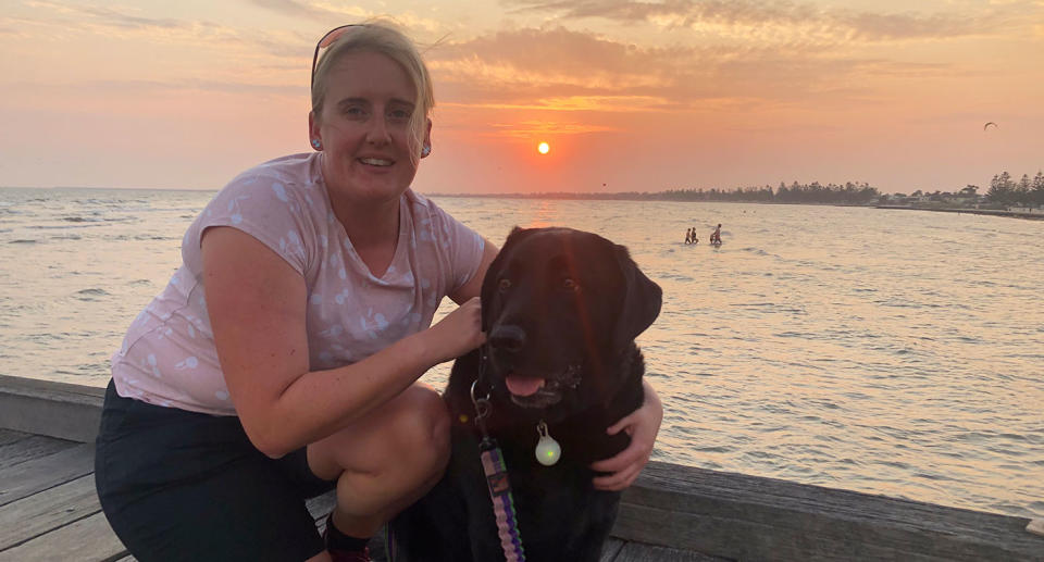 Casey Hyde is pictured with her guide dog Bridget.