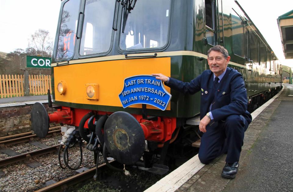 Peter Frost next to the SR Wareham Class 117 heritage diesel train at Corfe Castle (Andrew PM Wright/PA)