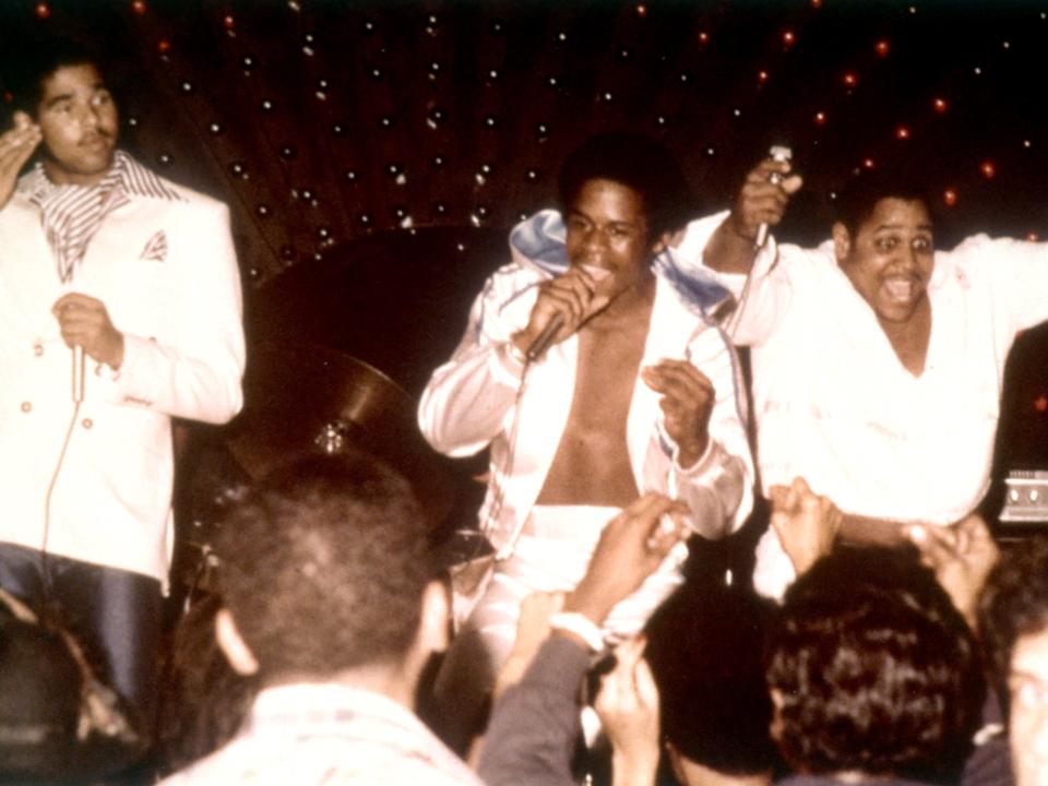 A photo of Sugar Hill Gang performing on stage together.