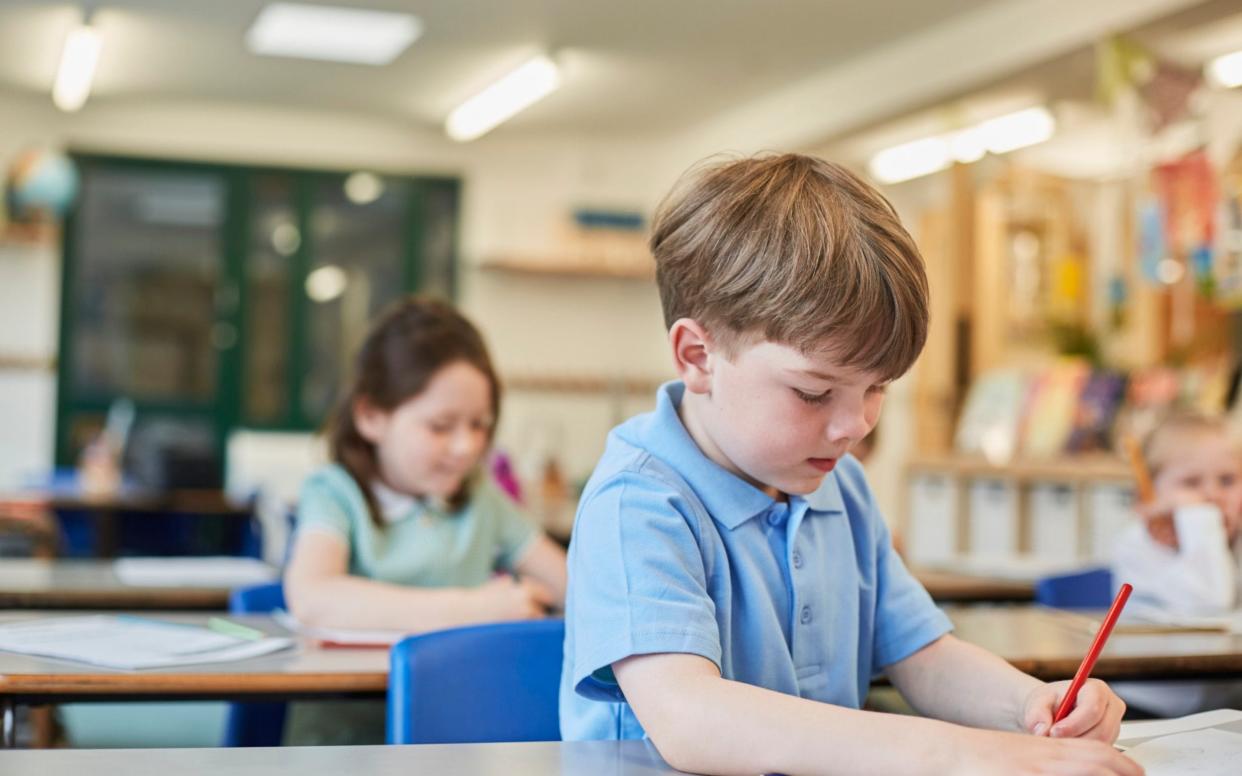 Small boy sitting in a lesson - Getty Images/ Cultura RF