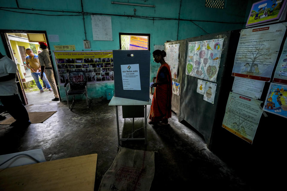 A woman casts vote during the first round of polling of India's national election in Bahona village, Jorhat, northeastern Assam, India, Friday, April 19, 2024. Nearly 970 million voters will elect 543 members for the lower house of Parliament for five years, during staggered elections that will run until June 1. (AP Photo/Anupam Nath)