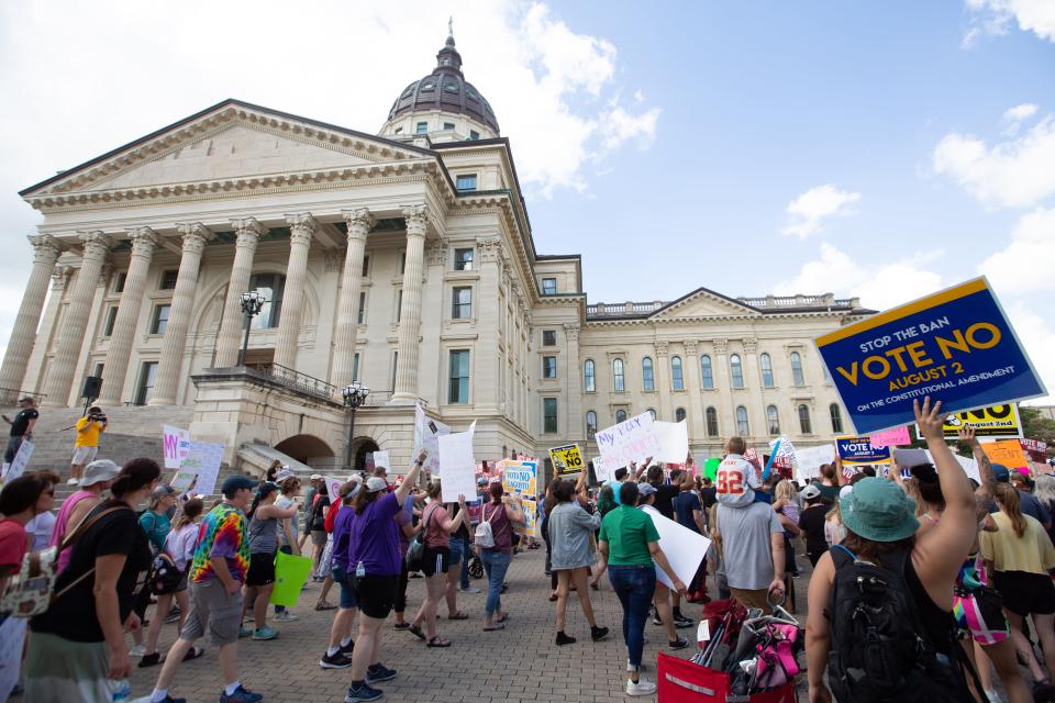 Hundreds of abortion-rights supporters begin to march around the Statehouse on Saturday.