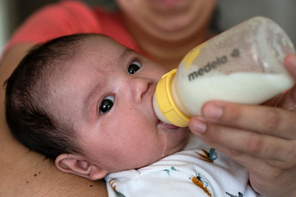 Two-month-old Jose Ismael GÃ¡lvez is fed a bottle of formula by his mother, Yury Navas, 29, of Laurel, Md., from her dwindling supply of formula at their apartment in Laurel, Md., Monday, May 23, 2022. After this day's feedings she will be down to their last 12.5 ounce container of formula. Navas doesn't know why her breastmilk didn't come in for her third baby and has tried many brands of formula before finding the one kind that he could tolerate well, which she now says is practically impossible for her to find. To stretch her last can she will sometimes give the baby the water from cooking rice to sate his hunger.