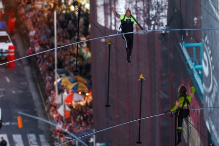 Aerialist Wallenda walks the highwire with his sister Lijana over Times Square in New York