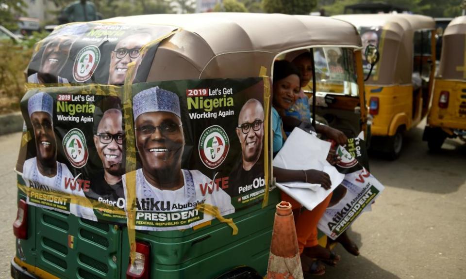 A rickshaw emblazoned with campaign posters for People’s Democratic party election candidate Atiku Abubakar.