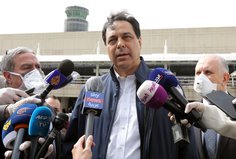 Lebanese Prime Minister Hassan Diab speaks to the media outside Beirut's international airport