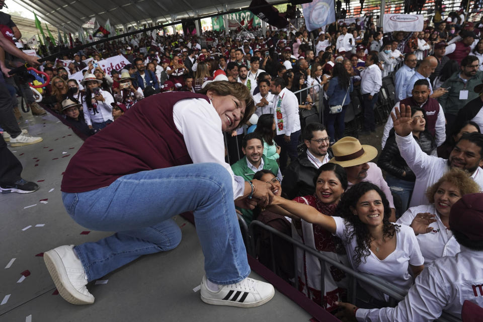 Delfina Gomez, left, MORENA political party gubernatorial candidate, greets supporters as she campaigns in Valle de Chalco, Mexico, Sunday, May 28, 2023. Voters in the state of Mexico go to the polls on June 4 to elect a new governor. (AP Photo/Marco Ugarte)