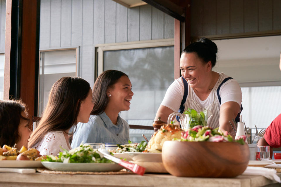 A woman serves her children food. Source: Coles (supplied)