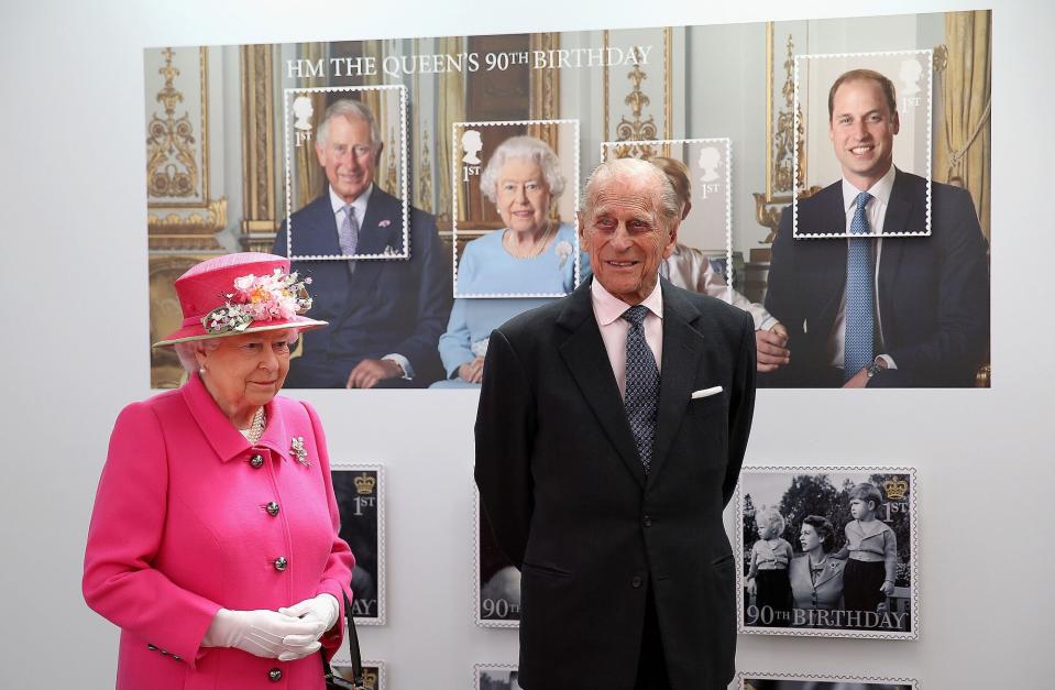 Britain's Queen Elizabeth II (L) and Britain's Prince Philip, Duke of Edinburgh pass a giant photograph taken to be used as part of a series of 10 Royal Mail postage stamps, to mark the monarch's 90th birthday, during her tour of the Royal Mail Windsor postal delivery office in Windsor, west of London, on April 20, 2016, to mark the 500th anniversary of the Postal Service. Queen Elizabeth II is set to celebrate her 90th birthday on April 21, with a family gathering and a cake baked by a reality television star, as a new poll finds Britain's longest serving monarch is as popular as ever. The queen has reigned for more than 63 years and shows no sign of retiring, even if she has in recent years passed on some of her duties to the younger royals.