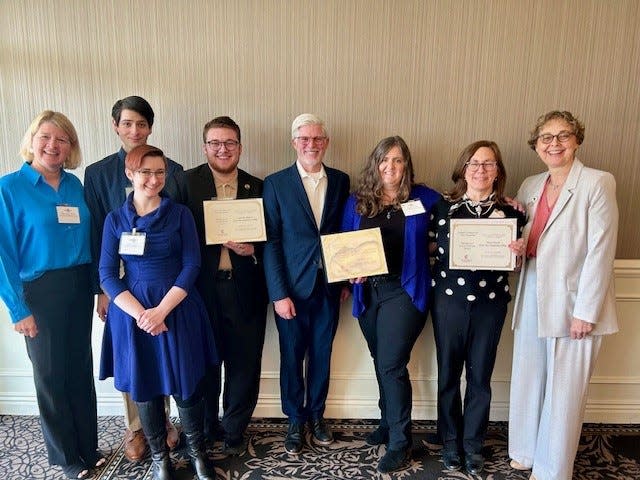 Campus Compact - all awardees: (from left): Kate Haley Webb, College Navigator, Great Bay Community College; Cory Viel, Student and Pride Alliance member; In front of him:, Samantha Claussen, Electronic Resources Librarian, Advisor Pride Alliance Club, Great Bay Community College; Louis Fowler, Student and Pride Alliance member; Craig Welch, Executive Director of Portsmouth Housing Authority; Andrea Pickett, Director of Community Outreach & Engagement, Portsmouth Housing Authority; Dawn Hamdi, Director, WorkReadyNH, Great Bay Community College; Dr. Cheryl Lesser, President, Great Bay Community College.