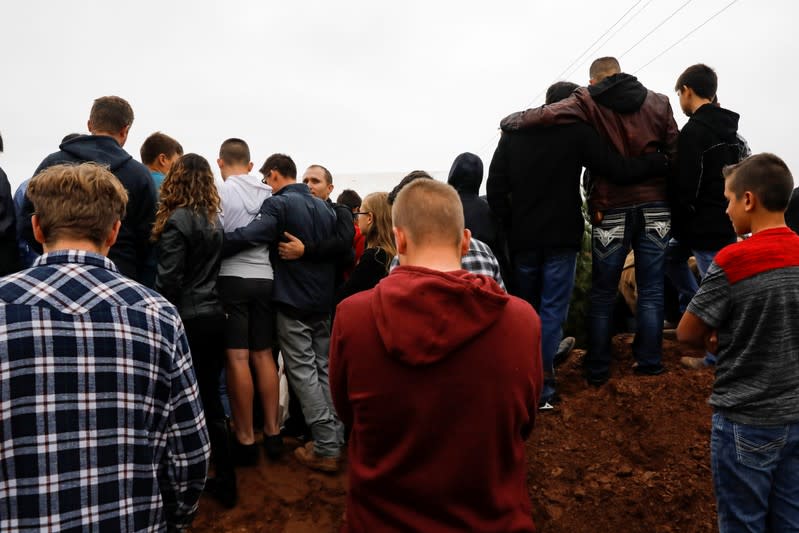 Relatives embrace during the burial of Rhonita Miller and her children Howard, Kristal, Titus, and Teana, who were killed by unknown assailants, in LeBaron, Chihuahua