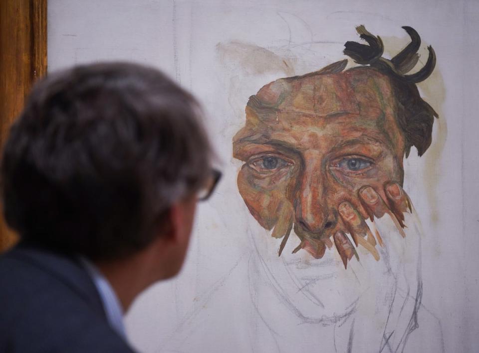 26 September 2022: A gallery staff member poses next to a painting by Lucian Freud - Self-portrait (Fragment), 1956 - on show at a photocall for the Credit Suisse exhibition - Lucian Freud: New Perspectives at the National Gallery in London (PA)