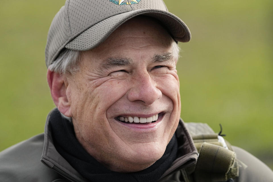 Texas Gov. Greg Abbott talks to the media after skydived in tandem Monday, Nov. 27, 2023, in Fentress, Texas. Abbott was invited to jump by 106-year-old World War II veteran Al Blaschke. (AP Photo/Eric Gay)