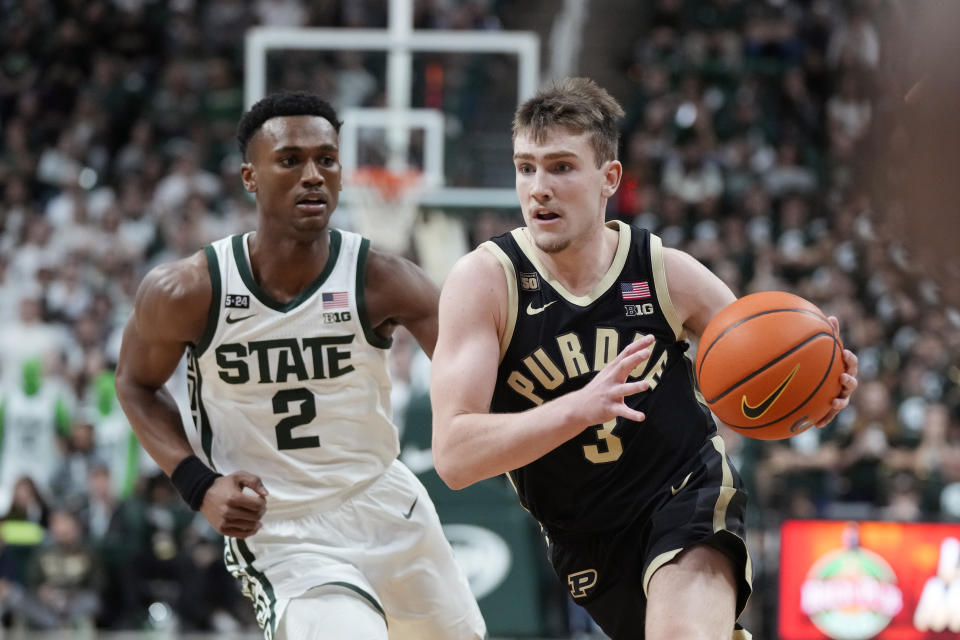 Purdue guard Braden Smith (3) brings the ball up court as Michigan State guard Tyson Walker (2) defends during the first half of an NCAA college basketball game, Monday, Jan. 16, 2023, in East Lansing, Mich. (AP Photo/Carlos Osorio)