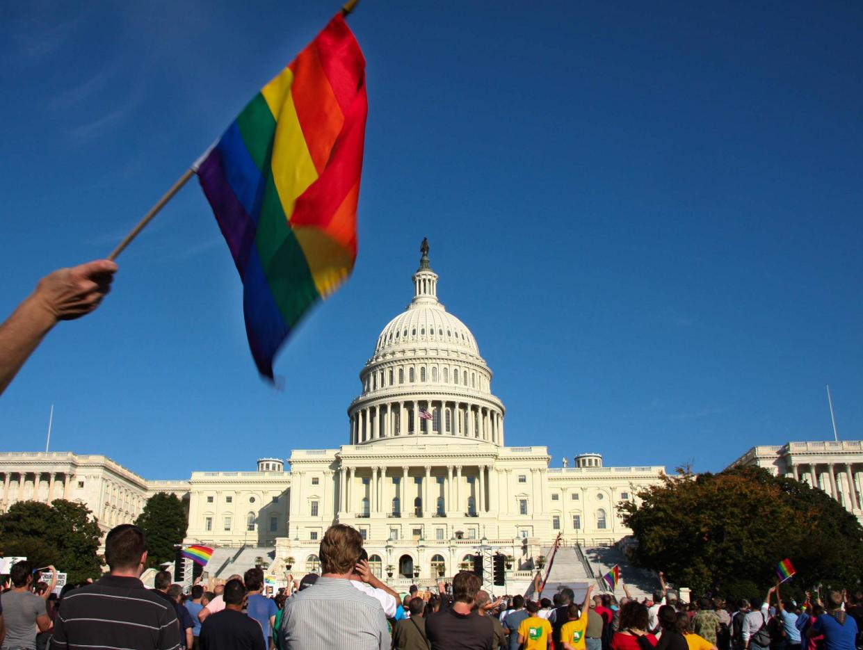 A demonstrator waves a rainbow flag in front of the US Capitol in Washington: Maria Belen Perez Gabilondo/AFP/Getty Images