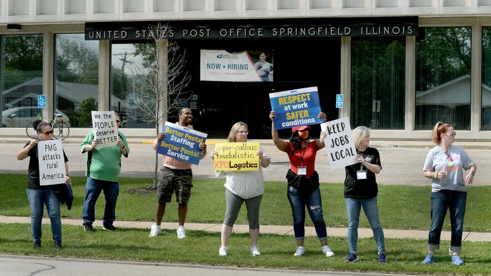 Postal workers picket in front of the E. Cook Street Post Office in Springfield Friday, May 3, 2024.