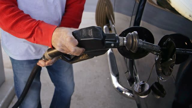 A customer prepares to pump gas at a gas station in Pembroke, Massachusetts.