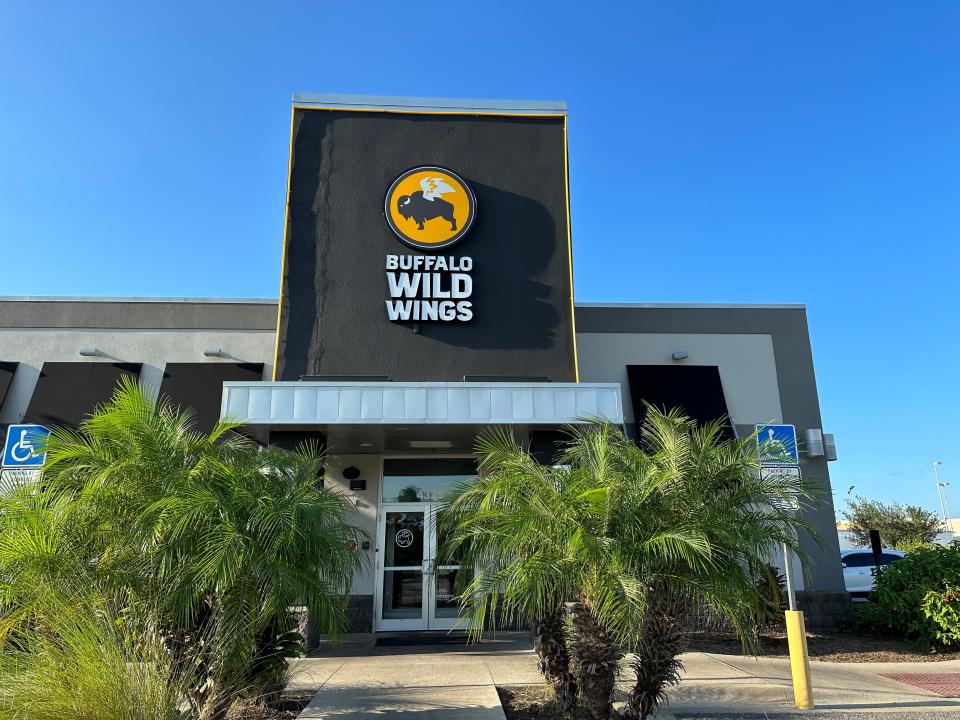 Buffalo Wild Wings exterior with palm trees in front