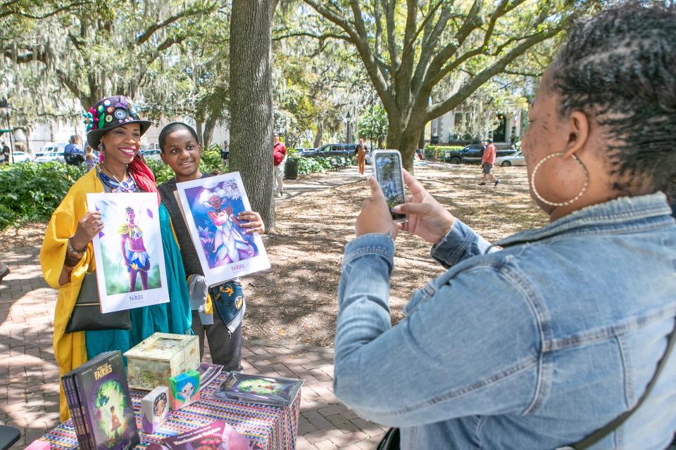 Savannah author Aiysha Sinclair poses for a photo with Karl Eburne, Jr., of Savannah, in Lafayette Square to celebrate the birthday of Flannery O'Connor.