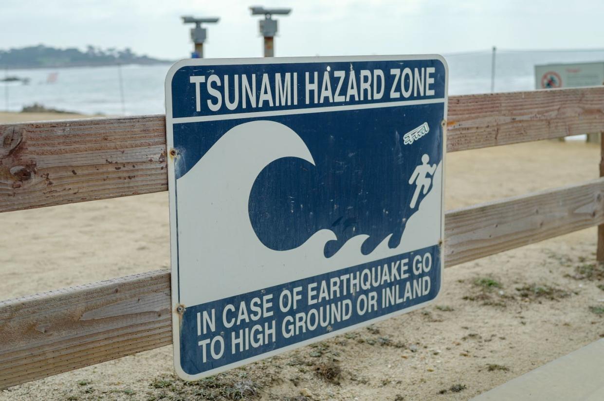 <span class="caption">On Jan. 15, 2022, coastal areas across California were placed under a tsunami warning. </span> <span class="attribution"><a class="link " href="https://www.gettyimages.com/detail/news-photo/sign-reading-tsunami-hazard-zone-and-with-a-graphic-of-a-news-photo/1341481367?adppopup=true" rel="nofollow noopener" target="_blank" data-ylk="slk:Gado via Getty Images;elm:context_link;itc:0;sec:content-canvas">Gado via Getty Images</a></span>