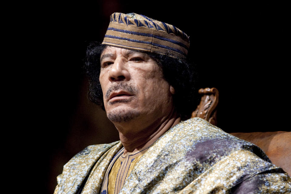 FILE - Libyan leader Muammar Gadhafi delivers his speech during a meeting with hundreds of prominent Italian women in a concert hall, in Rome, on June 12, 2009. Longtime Libyan dictator Moammar Gadhafi was charged with two counts of crimes against humanity for his brutal crackdown during the Arab Spring in 2011. The ICC issued an arrest warrant for Gadhafi in June 2011, but closed the case in November 2011, after his death. (AP Photo/Andrew Medichini, File)